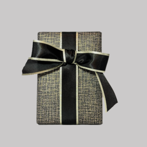 Gift Wrap Option with black and gold patterned wrapping paper and black ribbon with gold edge tied in a bow.